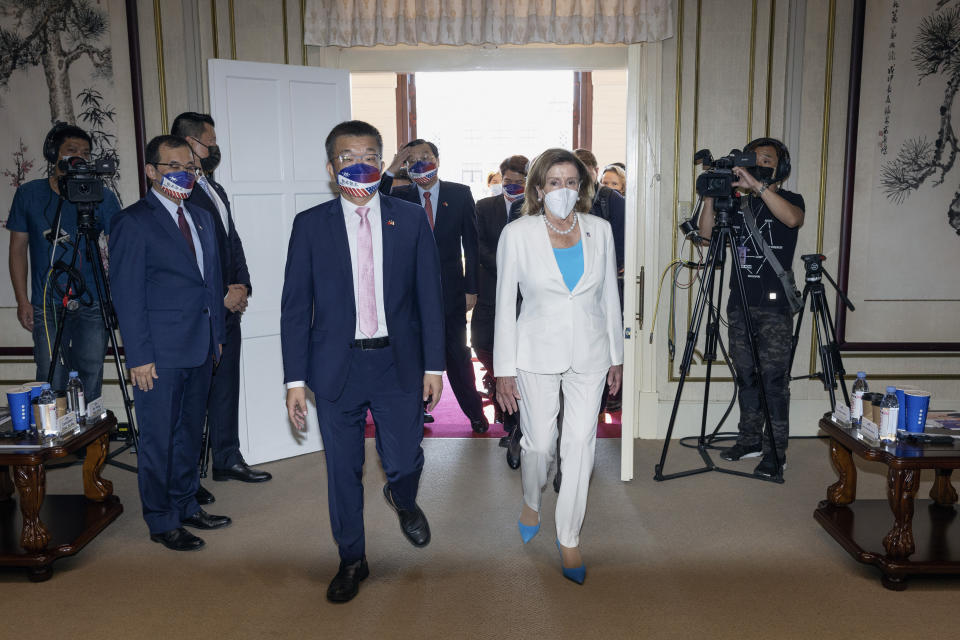 In this photo released by the Taiwan Legislative Yuan, U.S. House Speaker Nancy Pelosi, right, and Legislative Yuan Deputy Speaker Tsai Chi-chang arrive for a meeting in Taipei, Taiwan, Wednesday, Aug. 3, 2022. Pelosi, meeting top officials in Taiwan despite warnings from China, said Wednesday that she and other congressional leaders in a visiting delegation are showing they will not abandon their commitment to the self-governing island. (Taiwan Presidential Office via AP)