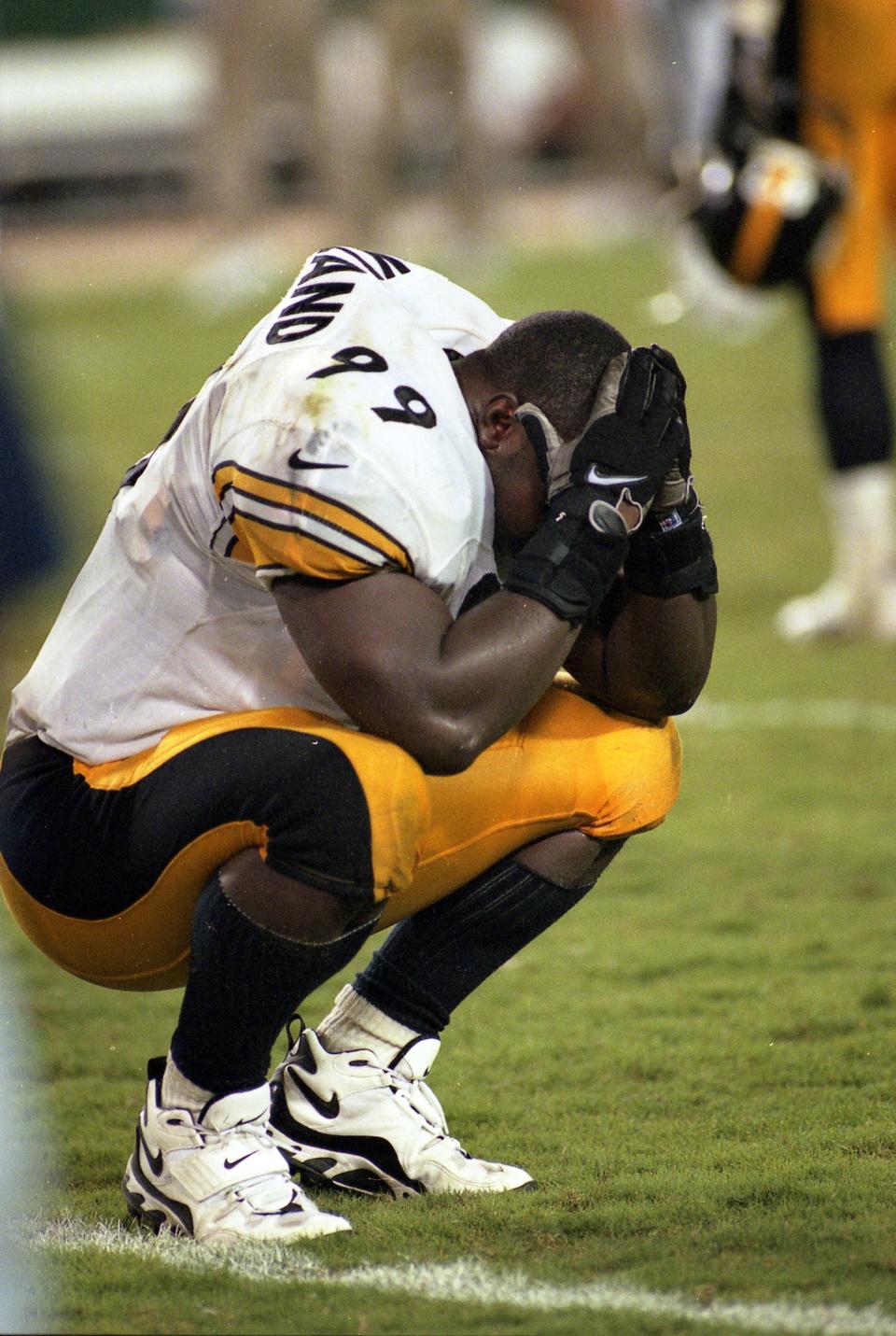 Pittsburgh Steelers linebacker Levon Kirkland buries his head in his hands after the Jaguars' Chris Hudson returned a blocked field-goal attempt 58 yards for a touchdown in a 30-21 Jags victory on Sept. 22, 1997, the team's first-ever Monday night football game.