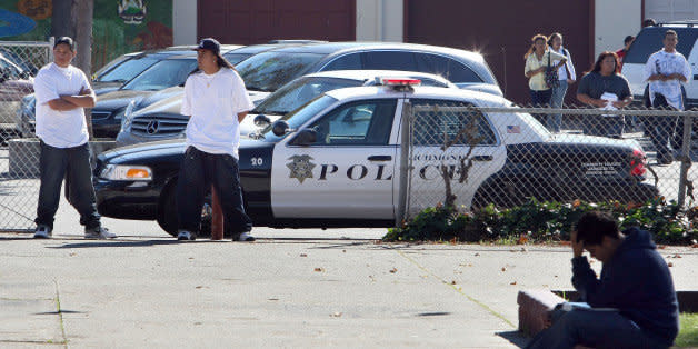 RICHMOND, CA - NOVEMBER 02:  Students walk by Richmond, California police car that is parked in front of Richmond High School November 2, 2009 in Richmond, California. Faith leaders held a prayer vigil at Richmond High School to show support for a fifteen year-old student who was gang raped by several men while attending a homecoming dance. Six arrests have been made in the case.  (Photo by Justin Sullivan/Getty Images) (Photo: )