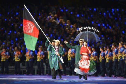 Members of Afghanistan's delegation parade during the opening ceremony of the London 2012 Paralympic Games at the Olympic Stadium. The Paralympic cauldron was lit in London on Wednesday to burn for 11 days of sport at the biggest and most high-profile Games that organisers hope will transform ideas about disability the world over