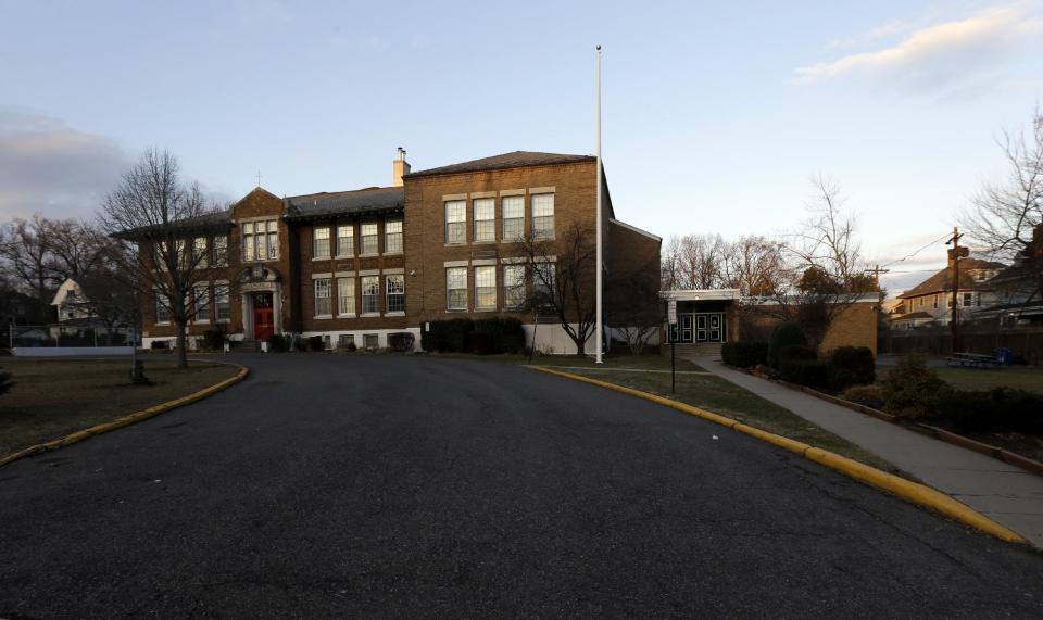 This Dec. 27, 2013, photo shows Linden Avenue Elementary School in Glen Ridge, N.J. A presidential commission appointed by President Barack Obama is grappling with concerns that some schools no longer want to serve as polling places amid security concerns since the shooting in Newtown, Conn. Among those schools that have closed to balloting is Linden Avenue Elementary School. (AP Photo/Julio Cortez)
