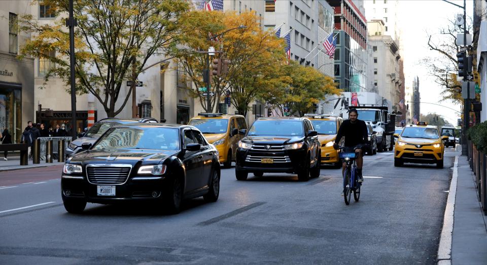 Traffic travels south on Fifth Avenue near West 50th street in New York City, Nov. 19, 2021. 