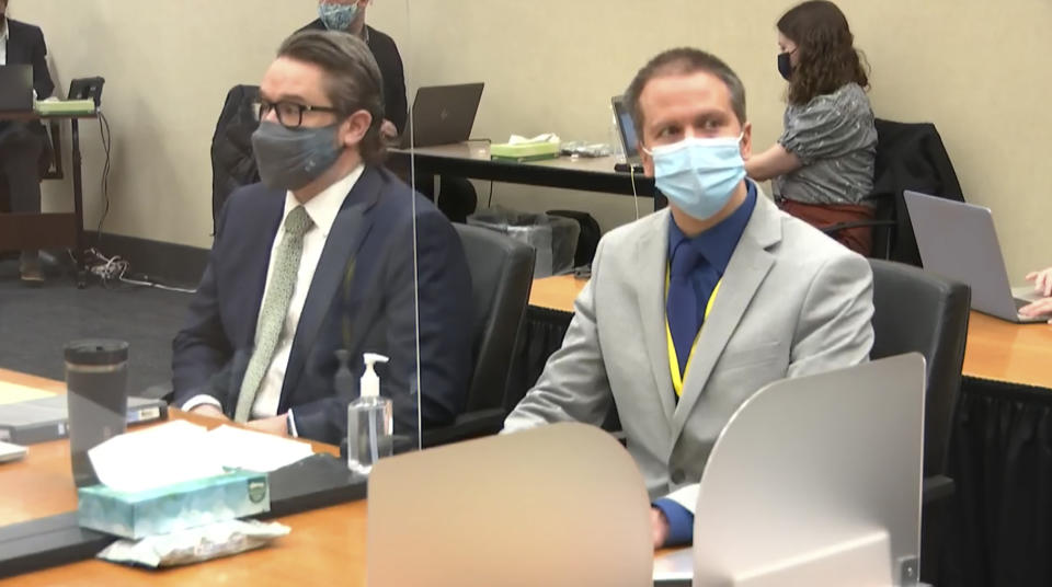 In this image from video, defense attorney Eric Nelson, left, and defendant, former Minneapolis police officer Derek Chauvin listen to Hennepin County Judge Peter Cahill read instructions to the jury before closing arguments, Monday, April 19, 2021, in the trial of Chauvin at the Hennepin County Courthouse in Minneapolis. Chauvin is charged in the May 25, 2020 death of George Floyd. (Court TV via AP, Pool)