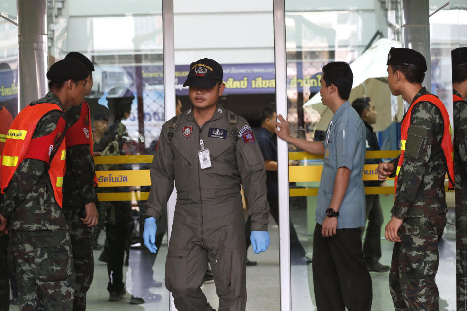 Investigators and police at the hospital in Bangkok: EPA