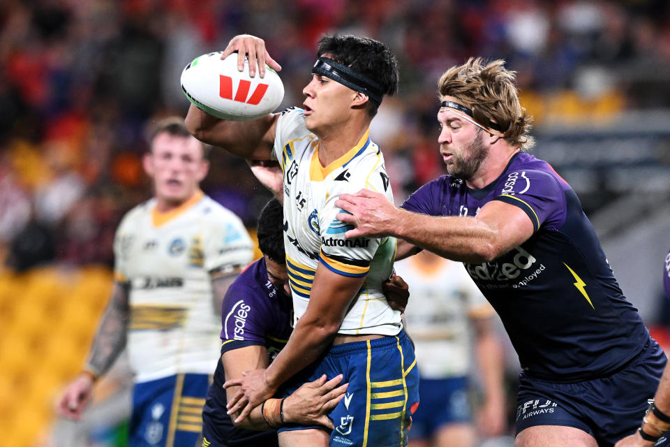 BRISBANE, AUSTRALIA - MAY 19: Blaize Talagi of the Eels passes as he is tackled during the round 11 NRL match between Melbourne Storm and Parramatta Eels at Suncorp Stadium, on May 19, 2024, in Brisbane, Australia. (Photo by Bradley Kanaris/Getty Images)