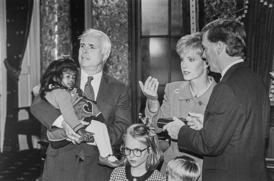 McCain, holding recently adopted Bridget, with wife Cindy Hensley, Vice President Dan Quayle and daughter Meghan during Mock Swearing on Jan. 7, 1993.