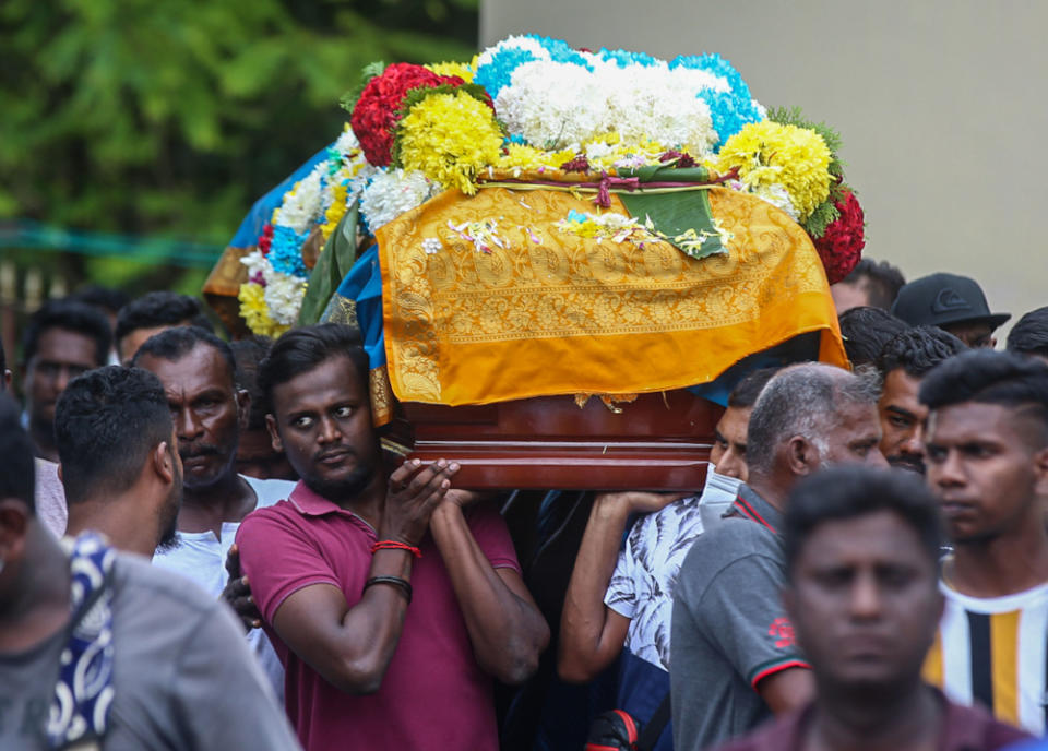 Family members carry Nagaenthran’s casket, April 29, 2022. — Picture by Farhan Najib