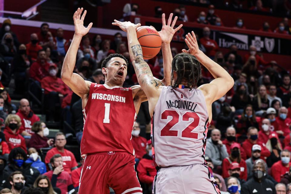 Feb 26, 2022; Piscataway, New Jersey, USA; Rutgers Scarlet Knights guard Caleb McConnell (22) battles Wisconsin Badgers guard Johnny Davis (1) for a loose ball during the first half at Jersey Mike's Arena. Mandatory Credit: Vincent Carchietta-USA TODAY Sports