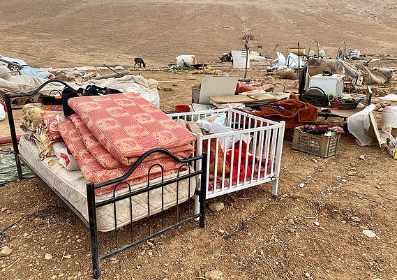 Beds and other family belongings sit in the dirt in what had been the small Palestinian settlement of Khirbet Humsa in the West Bank, in a photo provided by the United Nations Office for the Coordination of Humanitarian Affairs. / Credit: OCHA/UN