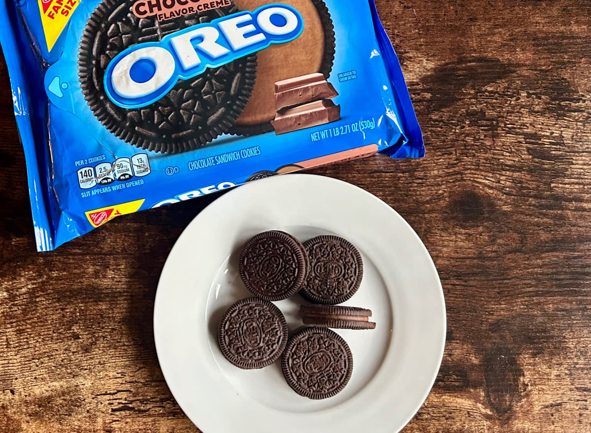 chocolate oreos on a plate next to package of chocolate oreos