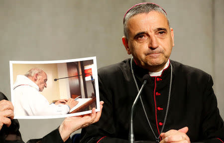 Archbishop of Rouen Dominique Lebrun is seen next to a picture of Father Jacques Hamel, the French priest knifed to death at his altar by Islamist militants in July, during a media conference at the Vatican, September 14, 2016. REUTERS/Stefano Rellandini