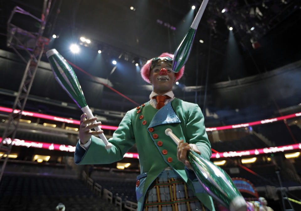 A Ringling Bros. and Barnum & Bailey clown juggles for fans during a pre show Saturday, Jan. 14, 2017, in Orlando, Fla. The Ringling Bros. and Barnum & Bailey Circus will end the "The Greatest Show on Earth" in May, following a 146-year run of performances. Kenneth Feld, the chairman and CEO of Feld Entertainment, which owns the circus, told The Associated Press, declining attendance combined with high operating costs are among the reasons for closing. (AP Photo/Chris O'Meara)