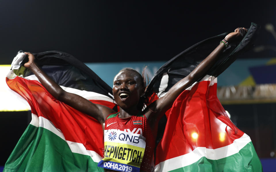 Ruth Chepngetich, of Kenya, celebrates winning the women's marathon at the World Athletics Championships in Doha, Qatar, Saturday, Sept. 28, 2019. (AP Photo/Petr David Josek)