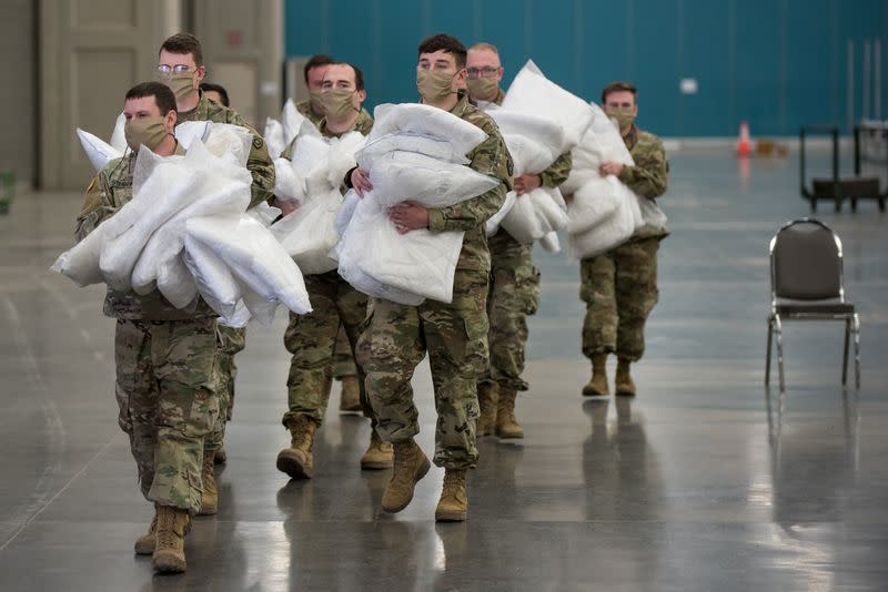 FILE PHOTO: Soldiers distribute hospital bed pillows in Louisville