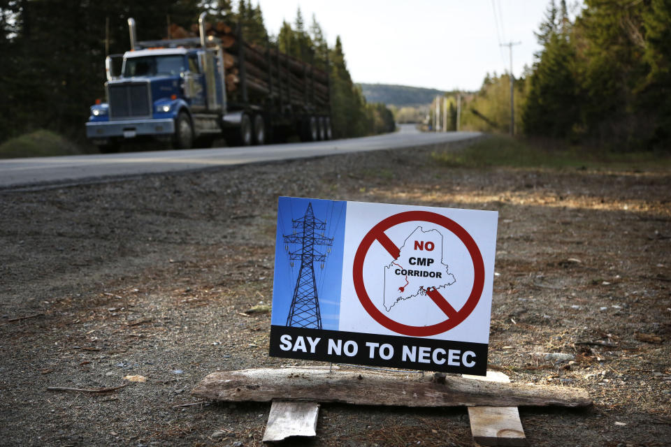 FILE - A sign with a protest message on Central Maine Power's controversial hydropower transmission corridor is displayed near Jackman, Maine. If voters grant their approval on Tuesday, Nov. 7, 2023, Maine would be the 10th state to close the loophole in federal election law that bans foreign entities from spending on candidate elections, yet allows donations for local and state ballot measures. (AP Photo/Robert F. Bukaty, File)