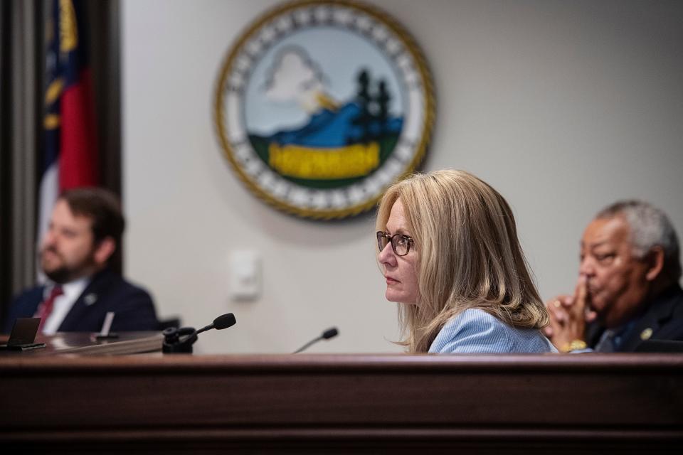 Amanda Edwards, center, listens to public comment with fellow county commissioners Parker Sloan, left, and Al Whitesides June 20, 2023.