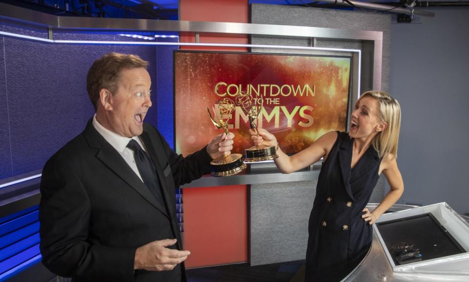KTLA's Sam Rubin and Jessica Holmes, on a set with Countdown to the Emmys on a screen.