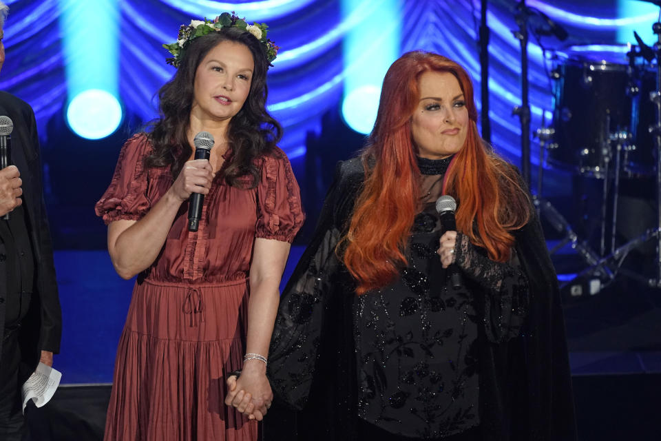 Ashley Judd, left, and Wynonna Judd speak during a tribute to their mother, country music star Naomi Judd, Sunday, May 15, 2022, in Nashville, Tenn. Naomi Judd died April 30. She was 76. (AP Photo/Mark Humphrey) - Credit: AP