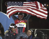 FILE - Ted Ligety of the United States, center, is chaired by teammates as he celebrates after winning the gold medal after the Men's Combined at the Turin 2006 Winter Olympic Games in Sestriere Colle, Italy, Tuesday, Feb. 14, 2006. Mikaela Shiffrin's record 83rd World Cup victory Tuesday, Jan. 24, 2023 is only the latest exploit by an American team that has been producing success after success on the circuit since Daron Rahlves and Bode Miller started it all off more than 20 years ago. (AP Photo/Kevin Frayer, File)