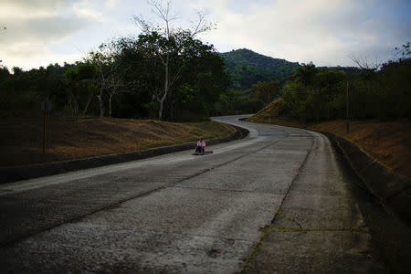 Farmer Candido Udaldo goes down the road using a homemade soap box cart in the village of Santo Domingo, in the Sierra Maestra, Cuba, March 30, 2018. REUTERS/Alexandre Meneghini