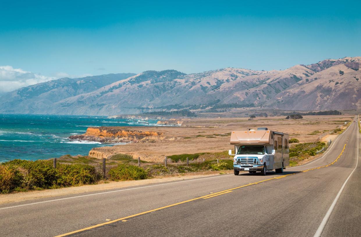 RV on Highway 1 Along Central Coast of California, sunny day, coast and ocean with mountains in the background