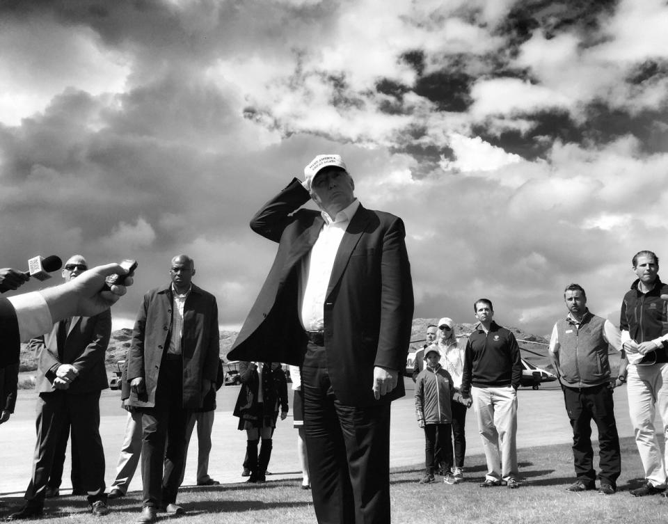 <p>Donald Trump holds on to his hat while speaking to reporters on June 25 at his golf course outside Aberdeen, Scotland. (Photo: Holly Bailey/Yahoo News) </p>