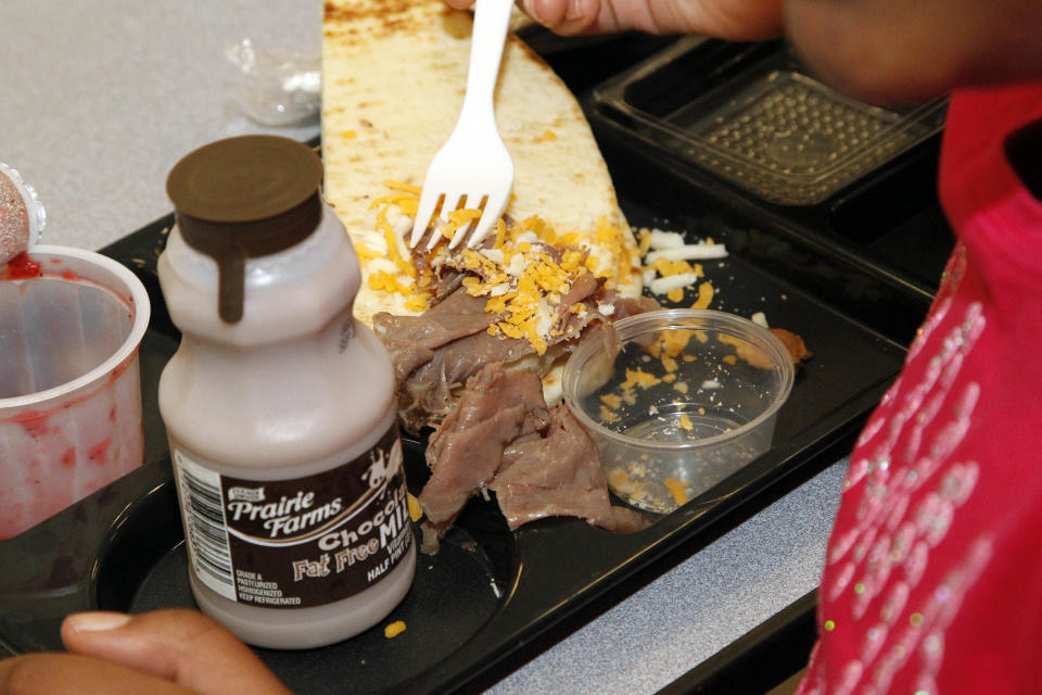 In spite of the nutritious value of this roast beef flat bread sandwich, this Eastside Elementary School student picks at it in Clinton, Miss., Wednesday, Sept. 12, 2012. The leaner, greener school lunches served under new federal standards are getting mixed grades from students. (AP Photo/Rogelio V. Solis)