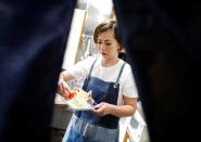 Yoko Ichihara cooks deep-fried whale nuggets inside the kitchen at her restaurant named P-man in Minamiboso