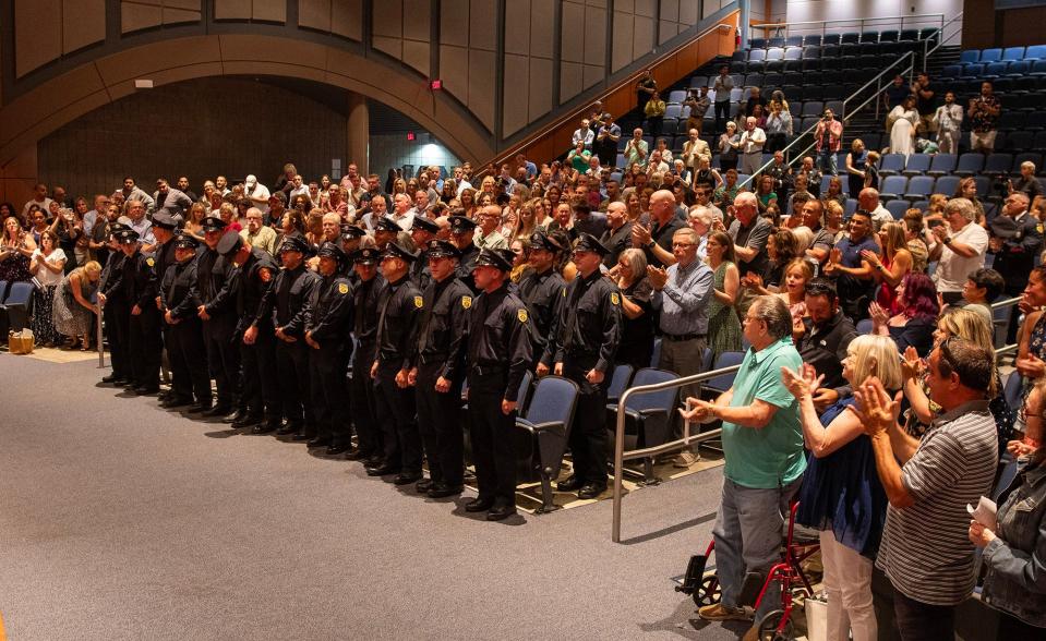 Newly sworn firefighters get a standing ovation from family and supporters during the Worcester Fire Department recruit class graduation ceremony at Worcester Technical High School Friday.