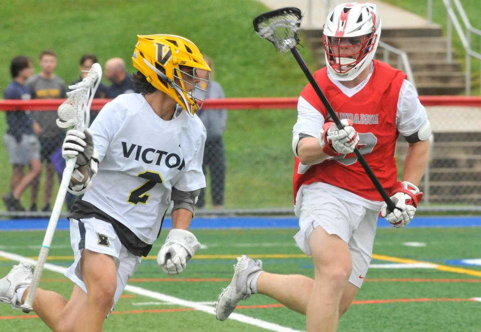 Victor's Jack Herendeen, left, protects the ball against the defense of Canandaigua's Eric Platten during Saturday's Class B semifinal.