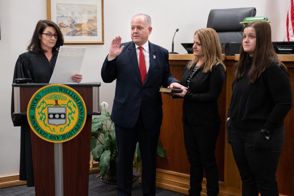 New Bucks County Sheriff Fred Harran  is sworn into office by Judge Denise Bowman with his fiancee Lisa DeSimone holding the Bible and his daughter Miranda Harran in attendance.