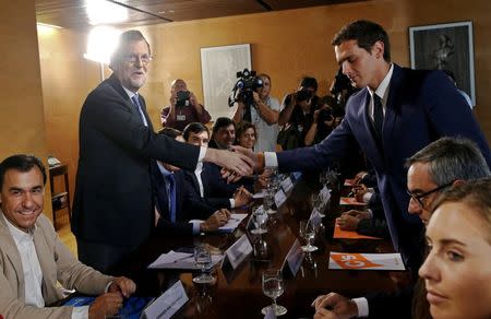 Spain's acting Prime Minister Mariano Rajoy (L) and Ciudadanos leader Albert Rivera shake hands during their meeting at the parliament in Madrid, Spain August 28, 2016. REUTERS/Andrea Comas