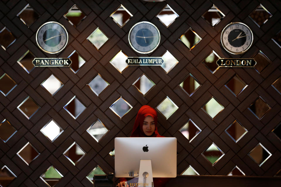 A receptionist works at the Al Meroz hotel in Bangkok