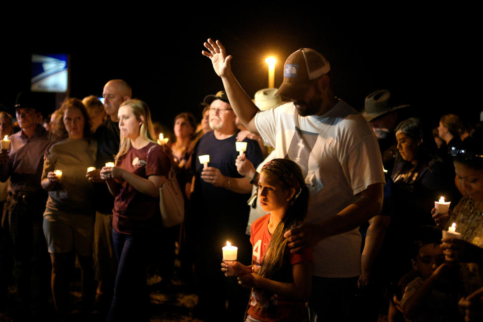 <p>Ramiro and Sofia Martinez attend a candle light vigil after a mass shooting at the First Baptist Church in Sutherland Springs, Texas, Nov. 5, 2017. (Photo: Sergio Flores/Reuters) </p>