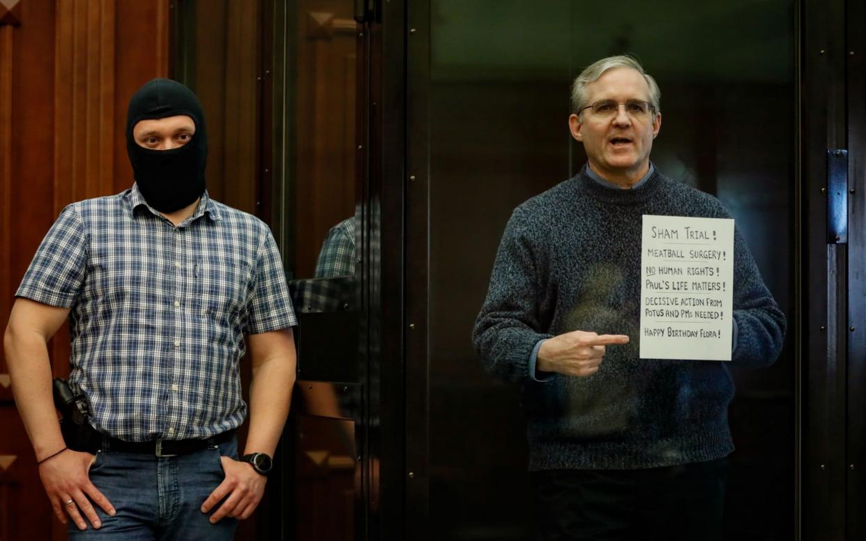 Paul Whelan, right, stands in a Moscow courtroom