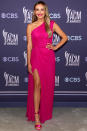 <p>pops in pink in her one-shoulder Monique Lhuillier high-slit gown, accessorized matching pink sandals and jewelry by Anabela Chan.</p>