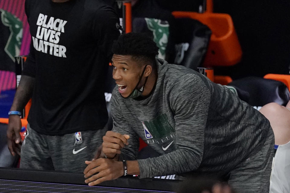 FILE - In this Sept. 8, 2020 file photo, Milwaukee Bucks' Giannis Antetokounmpo, center, shouts from the bench in the first half of an NBA conference semifinal playoff basketball game against the Miami Heat in Lake Buena Vista, Fla. Antetokounmpo has appeared in a government ad in his native Greece, released ahead of Christmas to urge people to observe public safety measures during the pandemic. (AP Photo/Mark J. Terrill, File)