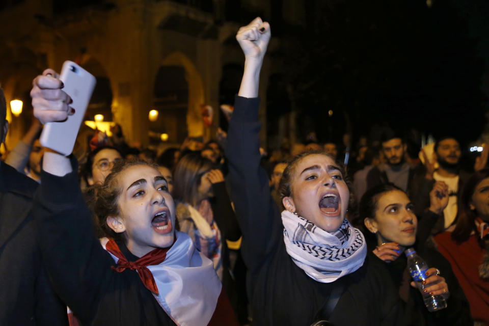Protesters chant slogans during ongoing protests against the Lebanese political class, in downtown Beirut, Lebanon, Sunday, Dec. 22, 2019. Lebanon's new prime minister held consultations Saturday with parliamentary blocs in which they discussed the shape of the future government. The next administration will have to steer the country out of its worst economic and financial crisis in decades. (AP Photo/Bilal Hussein)