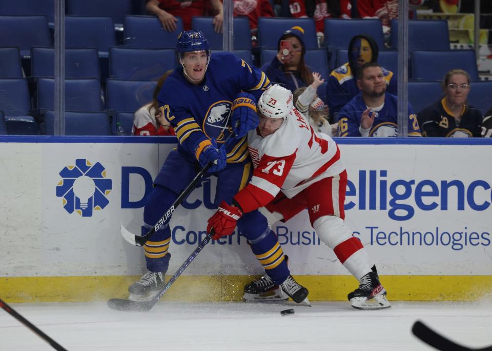 Detroit Red Wings left wing Adam Erne (73) hits Buffalo Sabres right wing Tage Thompson (72) as he clears the puck during the first period at KeyBank Center on Nov. 6, 2021.
