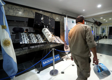 A man walks past a scaled-down replica of the SAOCOM 1-A/B satellite on display at Argentina's space agency CONAE in Buenos Aires, Argentina September 20, 2018. REUTERS/Marcos Brindicci