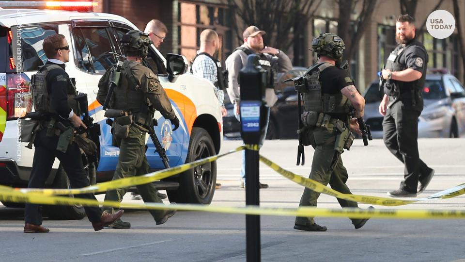 Officers arrive at the scene of a mass shooting in Louisville on Monday.