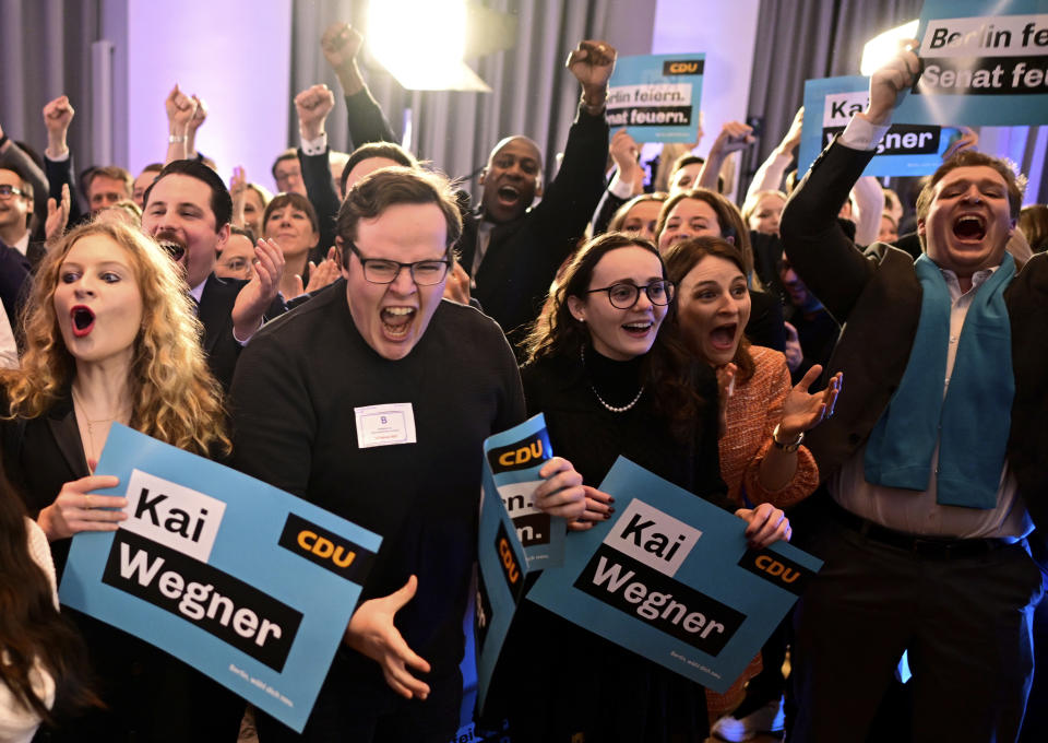 Supporters of the Christian Democratic Union party (CDU) cheer after the announcement of the first forecast after the state elections in Berlin, Germany, Sunday, Feb. 12, 2023. The city of Berlin on Sunday, Feb. 12, 2023, holds a court-ordered rerun of a chaotic 2021 state election that was marred by severe glitches at many polling stations. (Fabian Sommer/dpa via AP)