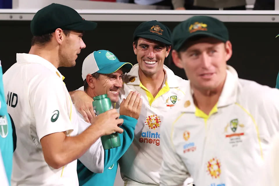 Pictured centre, former Aussie coach Justin Langer shares a moment with captain Pat Cummins after the Ashes. 