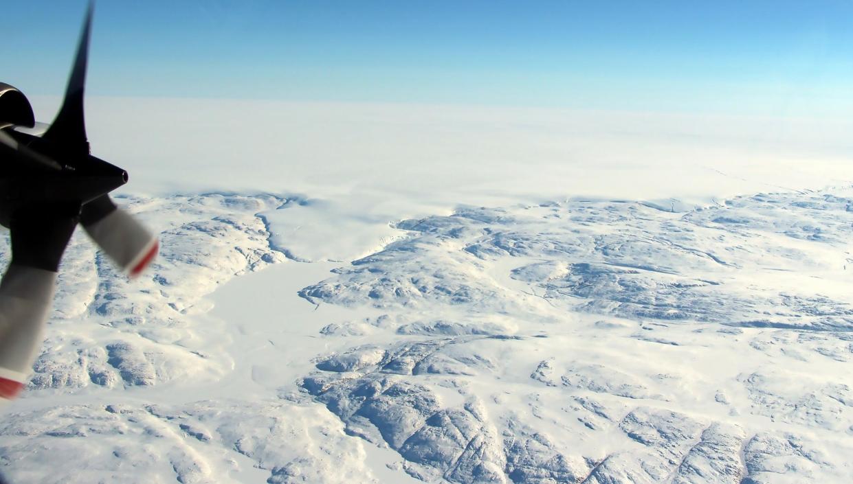 The Hiawatha impact crater is covered by the Greenland Ice Sheet and a tongue of ice that breaches the craters rim: NASA