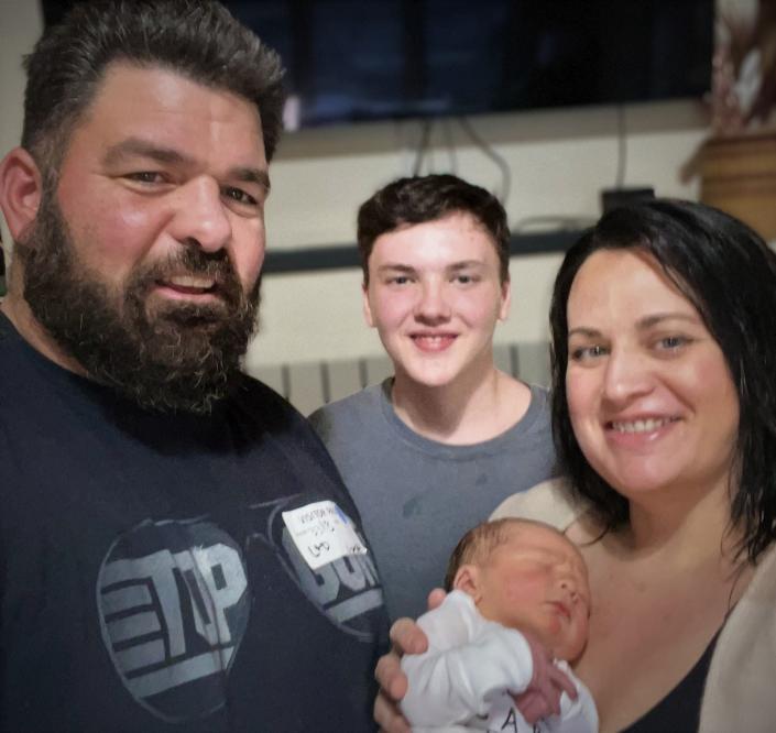 Harrison Todd was Shasta County&#39;s first baby born in 2022. He is joined by his father, Darin, left, brother Kyler Condit and mother Lacey.