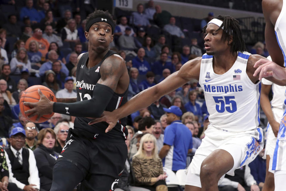 Memphis' forward Precious Achiuwa (55) defends Cincinnati's forward Tre Scott (13) in the first half of an NCAA college basketball game Thursday, Jan. 16, 2020, in Memphis, Tenn. (AP Photo/Karen Pulfer Focht)