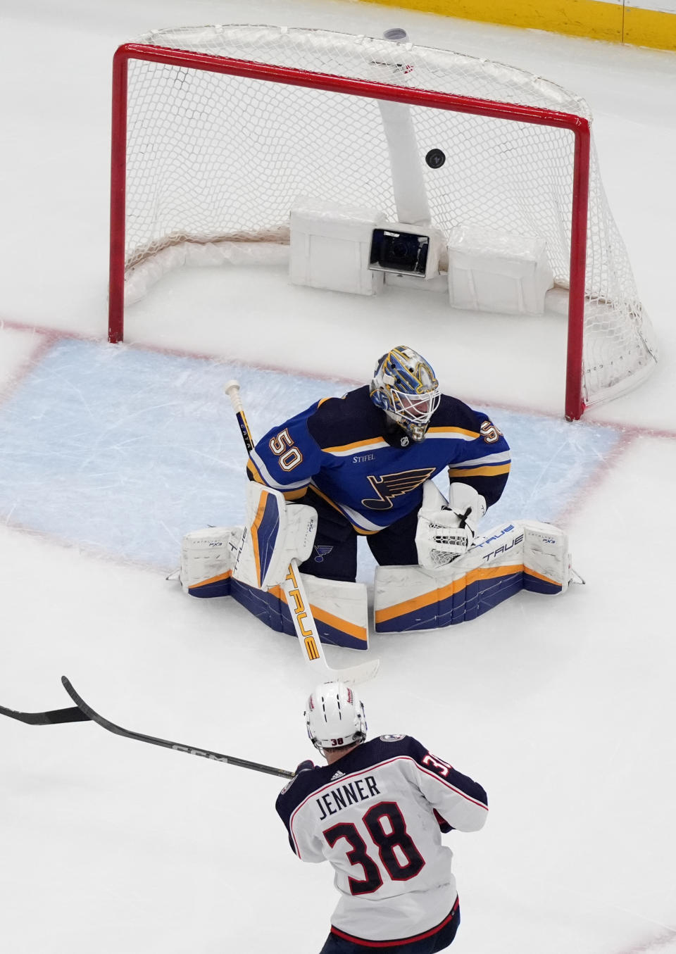 A shot by Columbus Blue Jackets' Boone Jenner (38) is unable to score as his shot bounces off the goalpost as St. Louis Blues goaltender Jordan Binnington (50) defends during the second period of an NHL hockey game Tuesday, Jan. 30, 2024, in St. Louis. (AP Photo/Jeff Roberson)