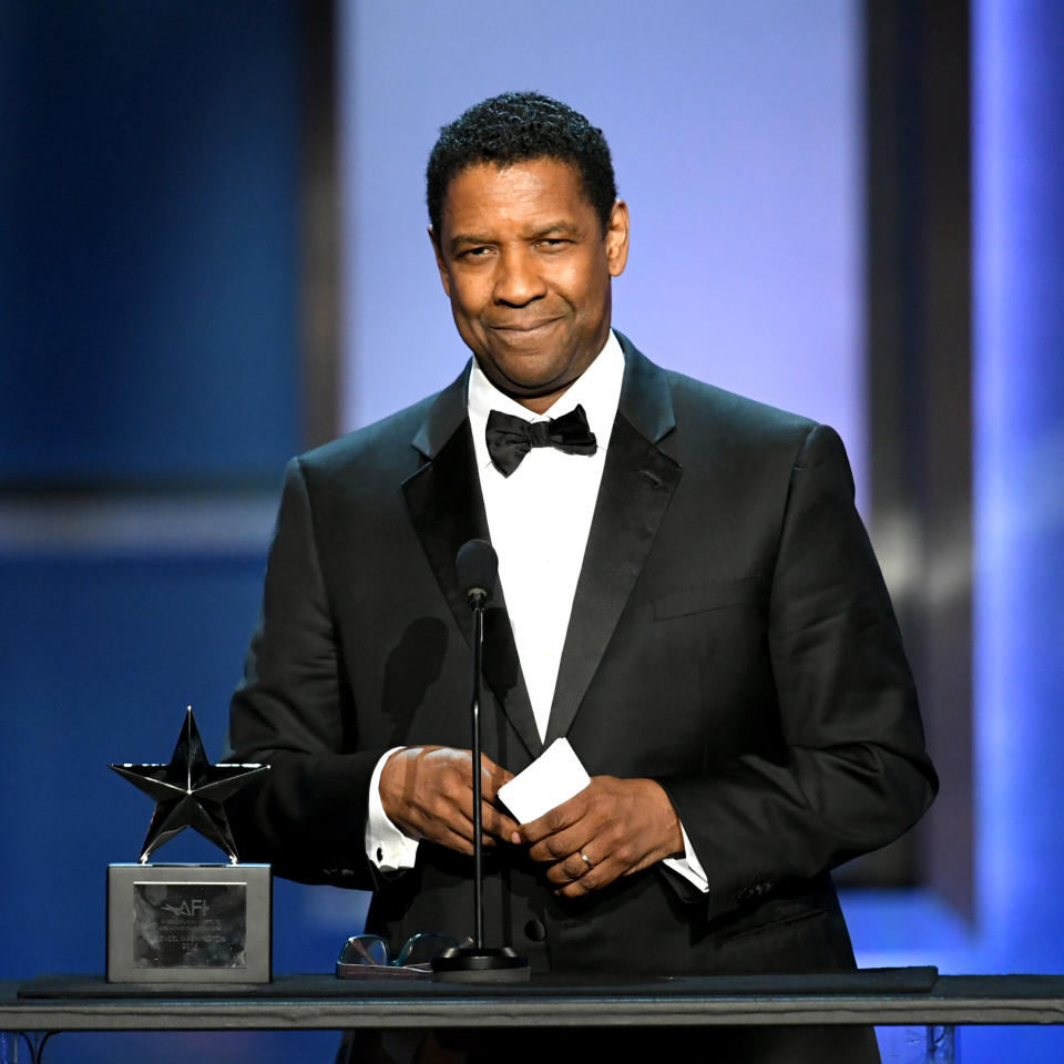 Presenting an award, wearing a bow tie