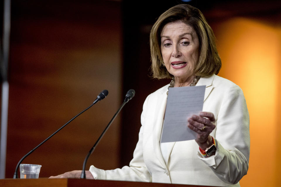 House Speaker Nancy Pelosi of Calif. reads from a paper titled "Know Your Rights" regarding ICE agents attempting to perform raids as she meets with reporters on Capitol Hill in Washington, Thursday, July 11, 2019. (AP Photo/Andrew Harnik)