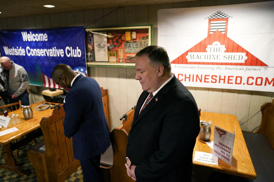 Former Secretary of State Mike Pompeo bows his head in prayers before speaking at the West Side Conservative Club, Friday, March 26, 2021, in Urbandale, Iowa. (AP Photo/Charlie Neibergall)